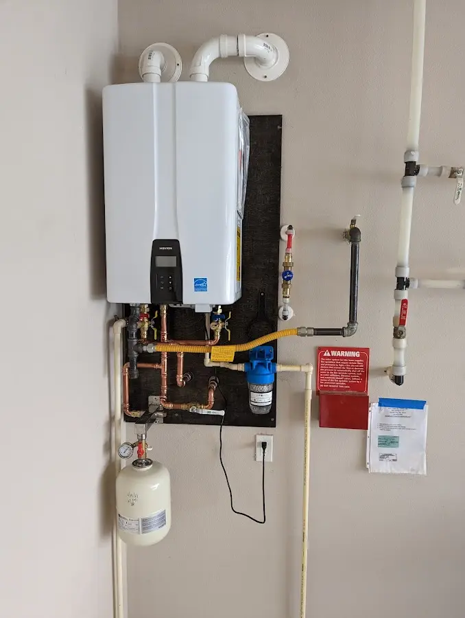 Professional plumber installing copper piping in a Broadmoor home